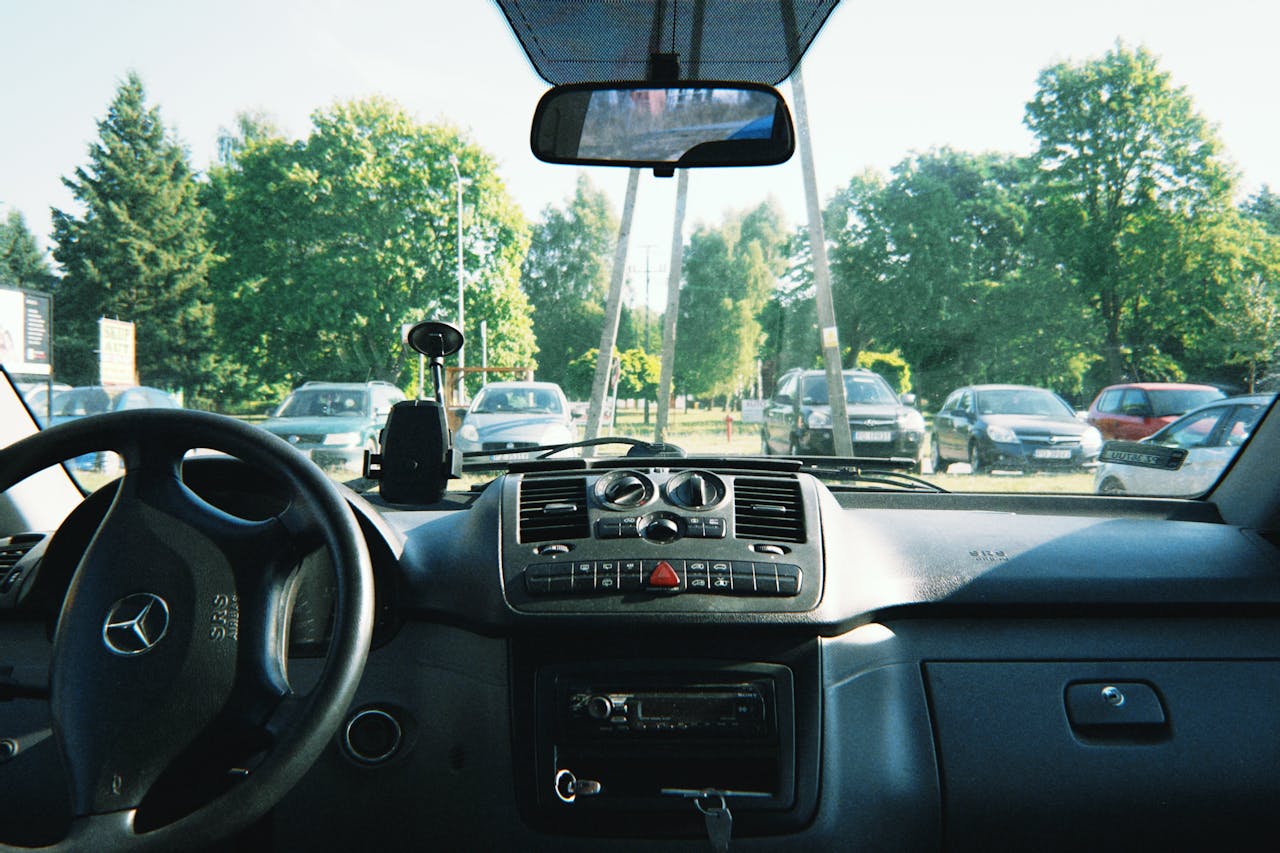 Dashboard and interior view of a parked Mercedes in Poznań, Poland.